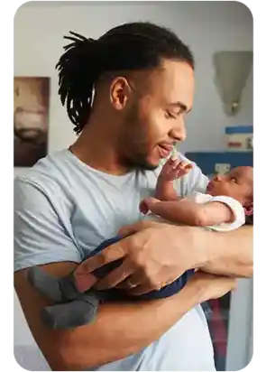 image of man holding a baby links to Donate page